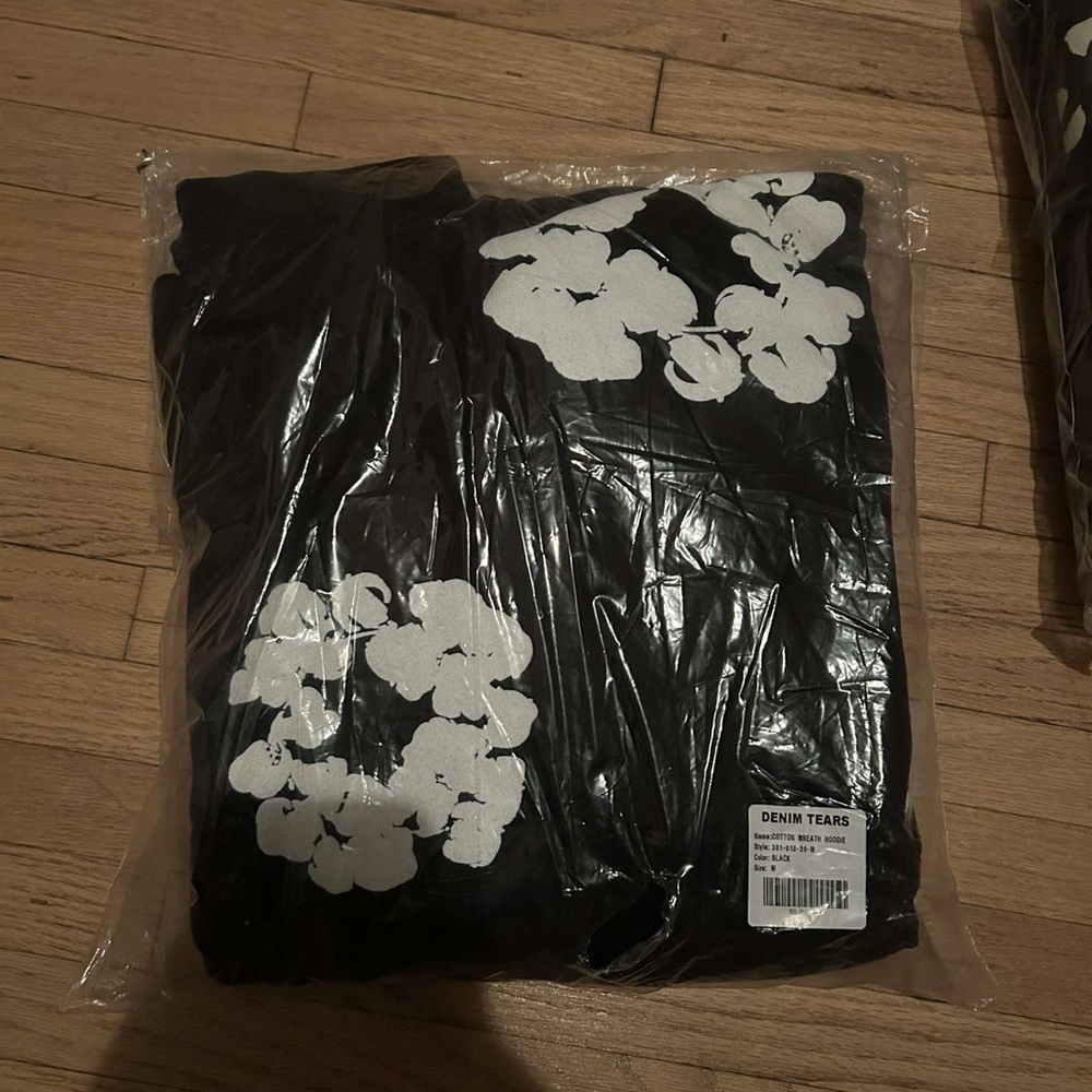 Denim Tears Black Hoodie with White Floral Design